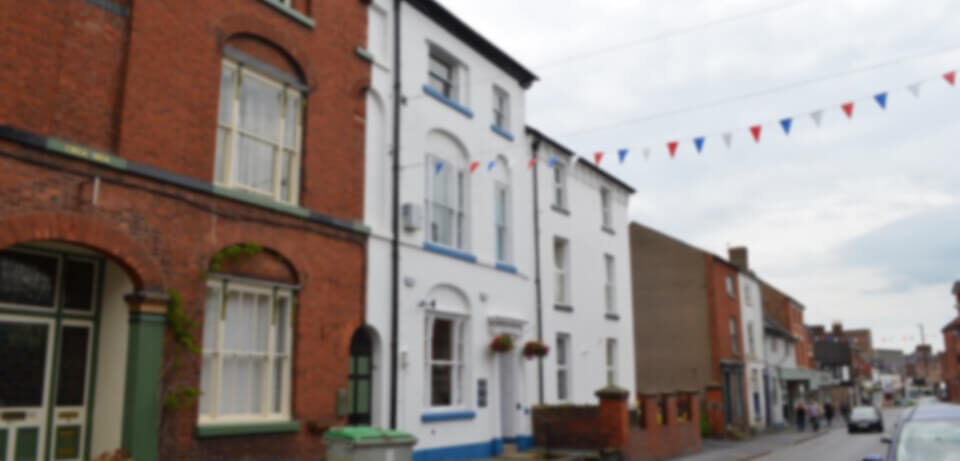 Willow Street in Oswestry, showing the practice's terrace of brick and white-rendered buildings
